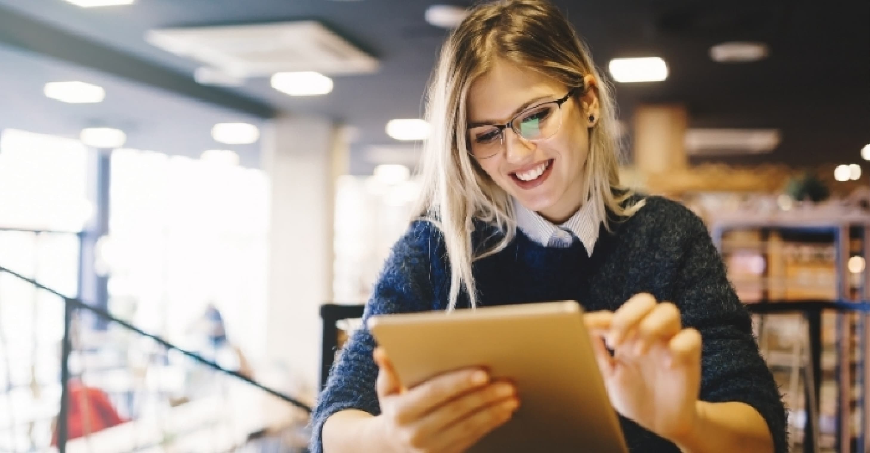 girl wearing glasses holding tablet